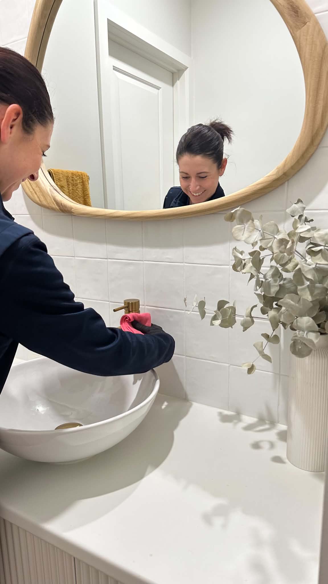 Person cleaning the bathroom sink