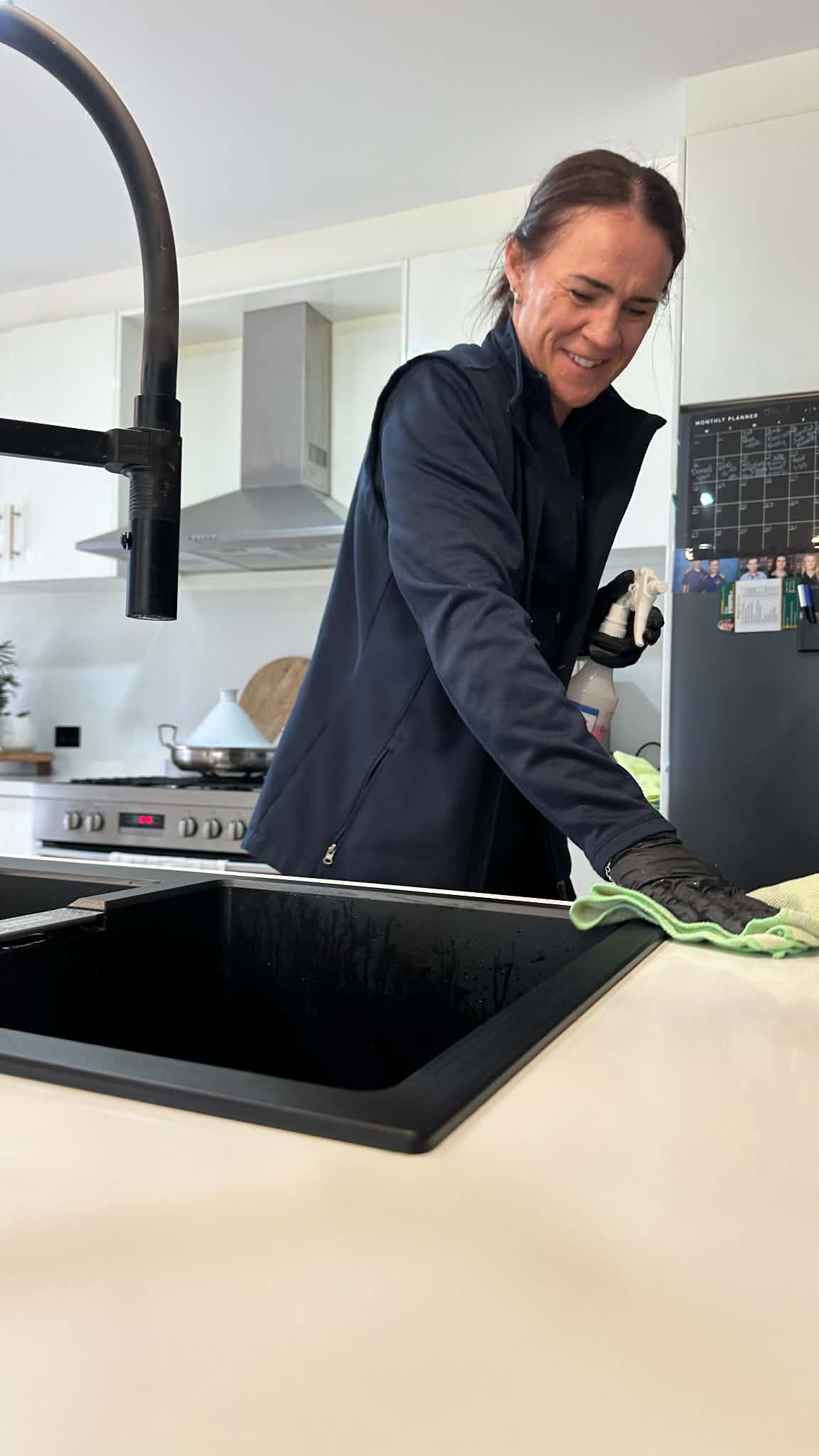 Person cleaning a window in a bright home
